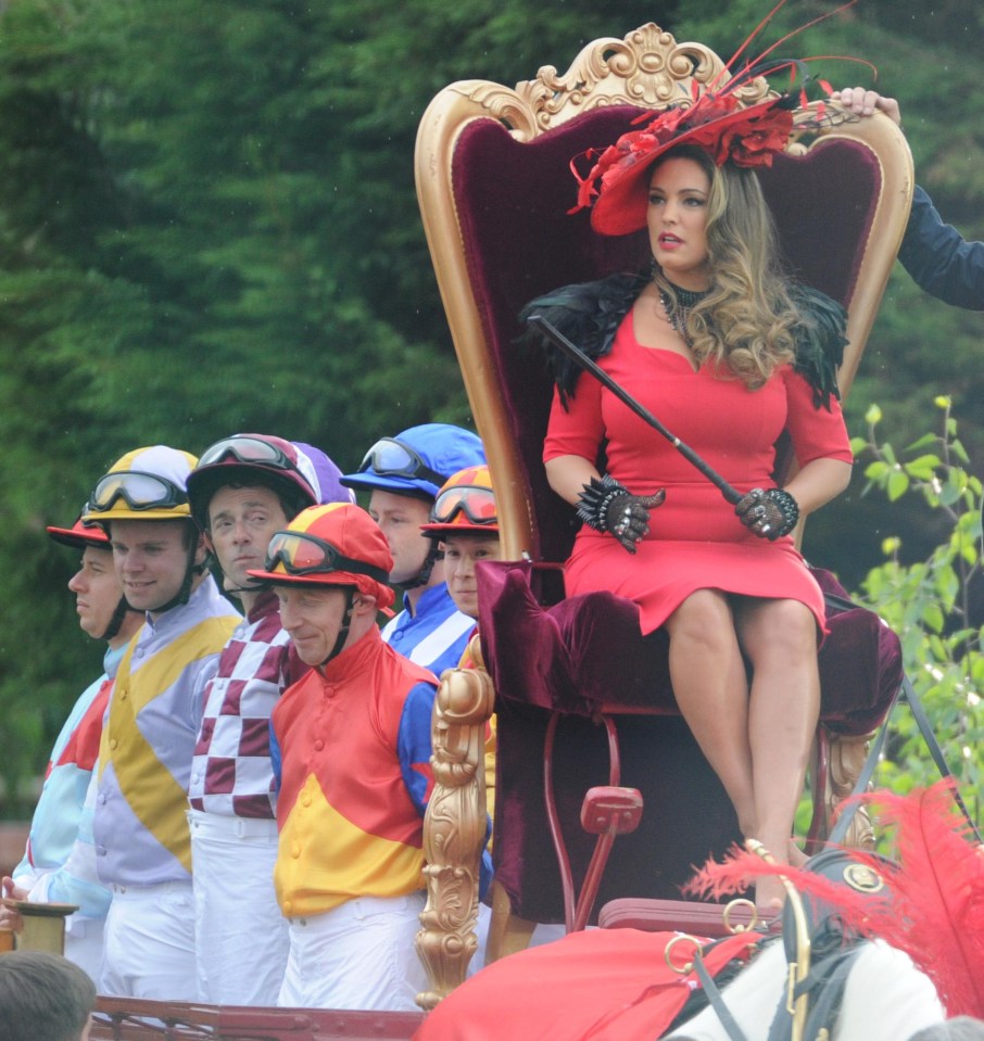 Kelly Brook rests on a throne as she films a new ad for bookies Ladbrookes