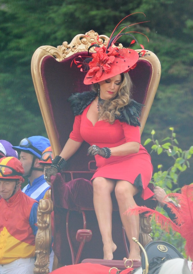 The 38-year-old appeared to take her shoes off at one point as she tried to get comfortable on the throne