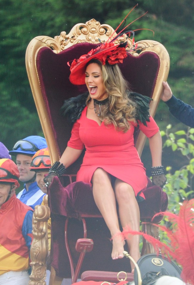 The model appeared to laugh at one point as she was helped on to the chair