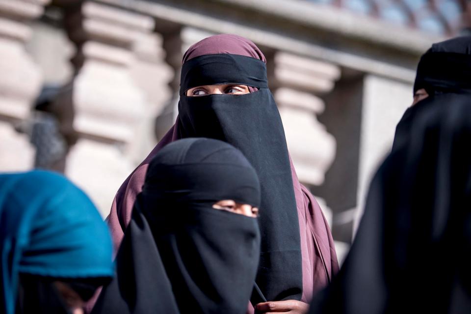  Women wearing the niqab stand outside the Danish Parliament today