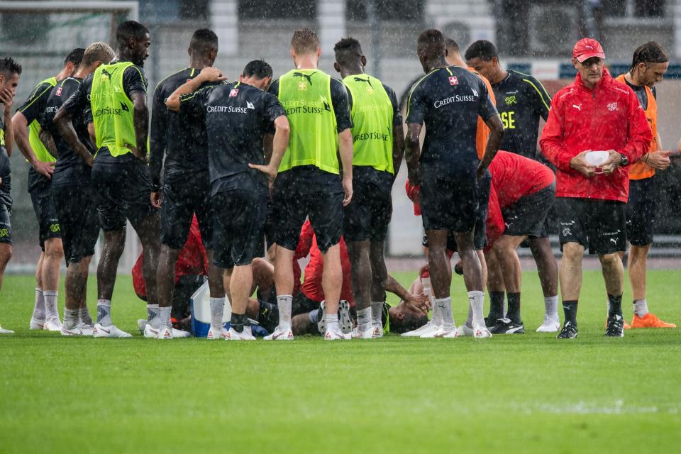  Xhaka was surrounded by his team-mates as he laid on the floor