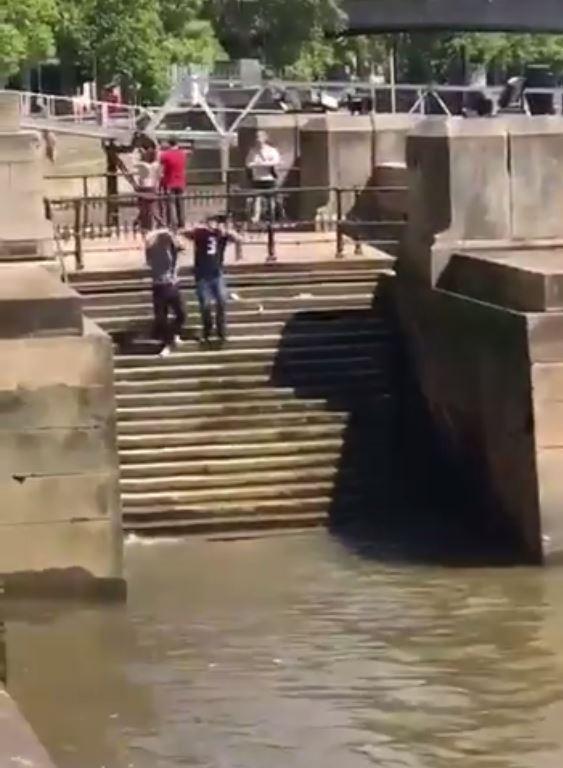  The pair whip off their tops heading for the Thames - moments before one of them takes a hilarious spill down the steps