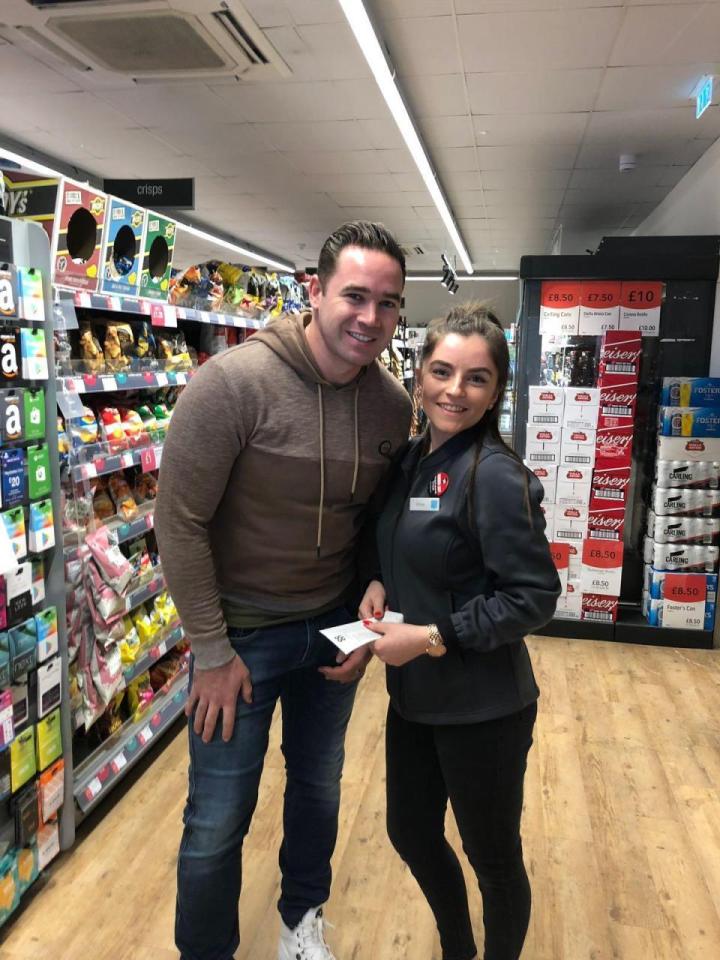  Kieran and Chloe posed together for a picture in the shop she works in