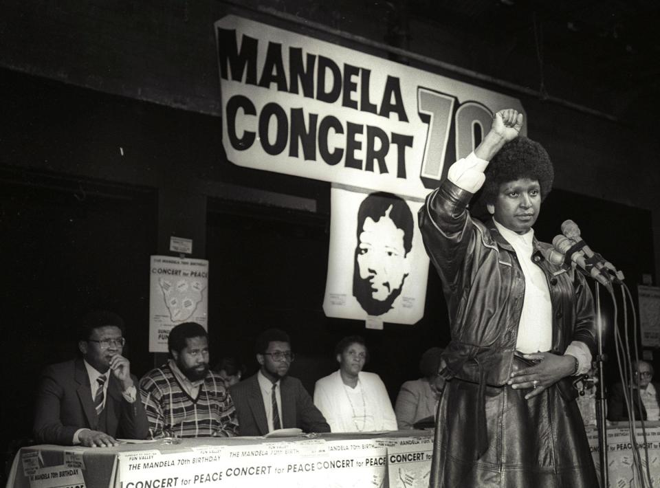  Winnie Mandela raises her fist in a black power salute in 1988 after announcing that a massive pop concert will be held to mark the 70th birthday of her husband