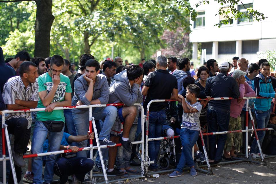  Migrants wait outside a reception centre in Berlin in 2015