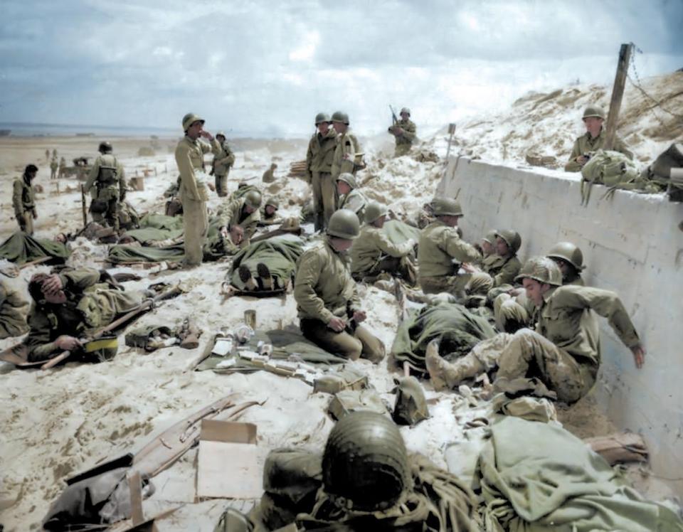  US Army Fourth Infantry Division troops take a breather after making their way onto Utah Red Beach