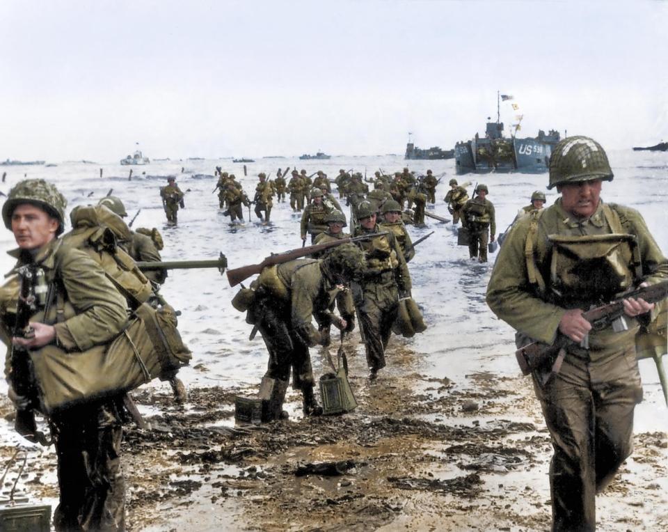  American troops arrive on a Normandy beach in a lengthy procession from their landing crafts