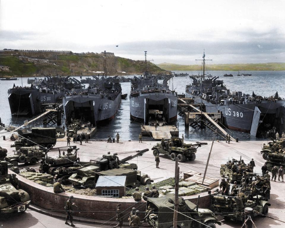  Troops load U.S. LSTs with artillery equipment, vehicles and troops in Brixham, England before they head for Normandy