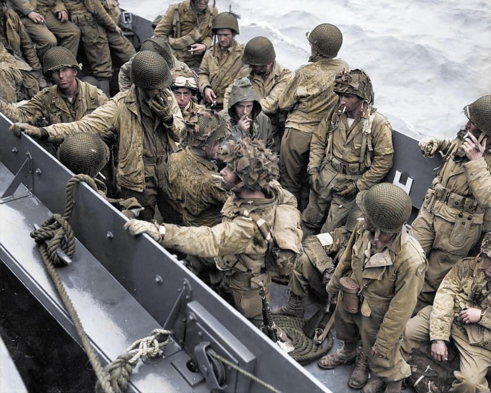  Glider pilots take the opportunity for a quick cigarette as they are crowded onto a landing craft