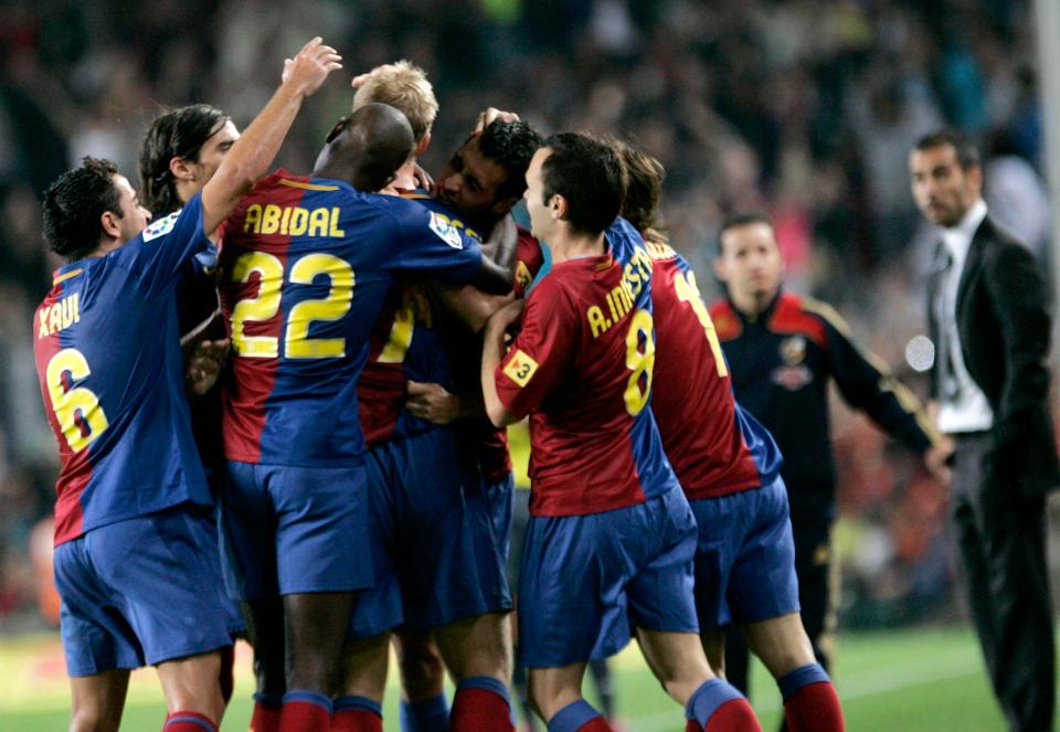 Gudjohnsen is mobbed by his Barcelona team-mates after scoring - and says he cannot recognise the claims of Toure