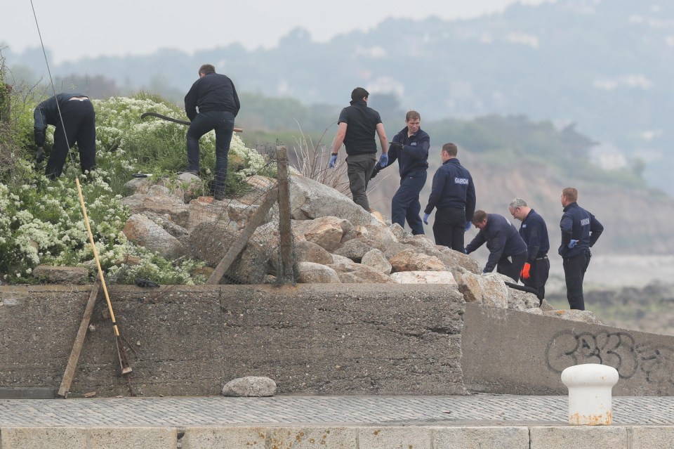 A Garda search team at the harbour wall in Bray, Co Wicklow, near to the Bray Boxing Club where three people were shot