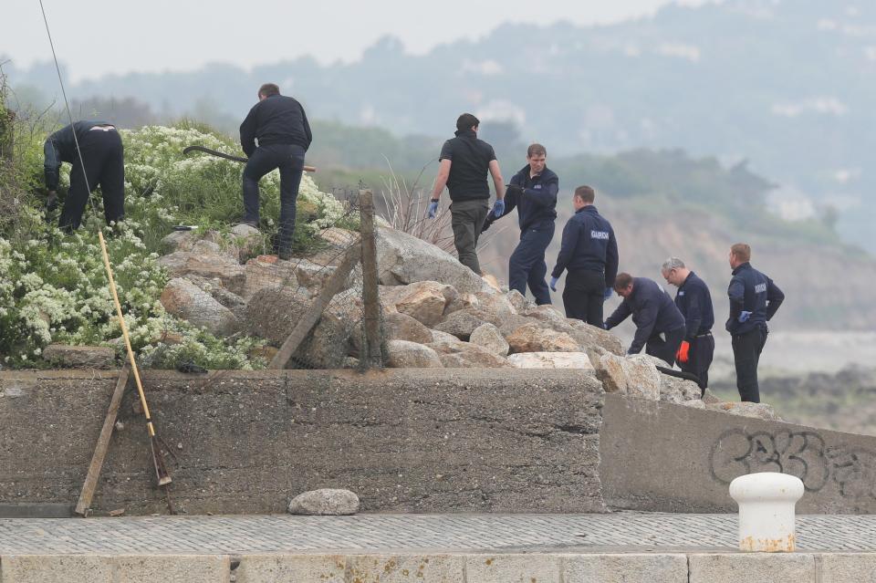  A Garda search team at the harbour wall in Bray, Co Wicklow, near to the Bray Boxing Club where three people were shot