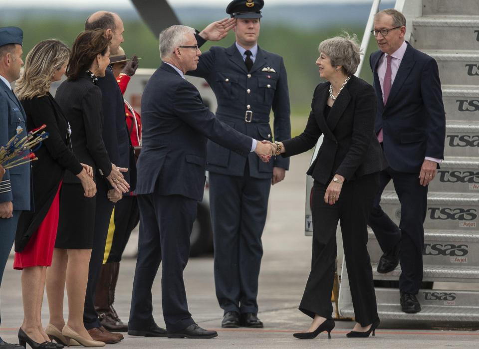  Theresa May is greeted by Canada's Chief of Protocol, Roy Norton, but relations with President Trump aren't so warm