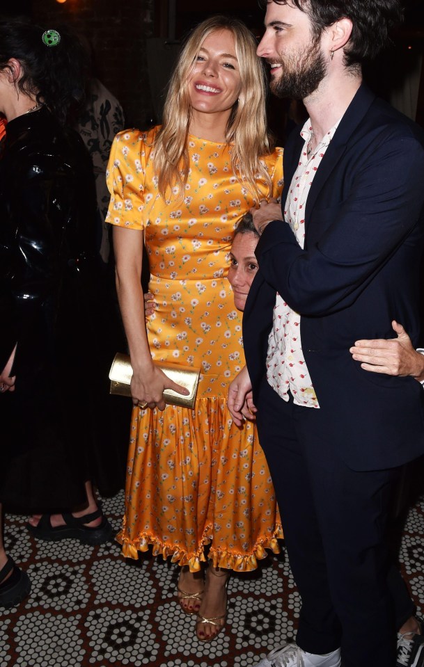 In New York, wearing an orange silky floral midi