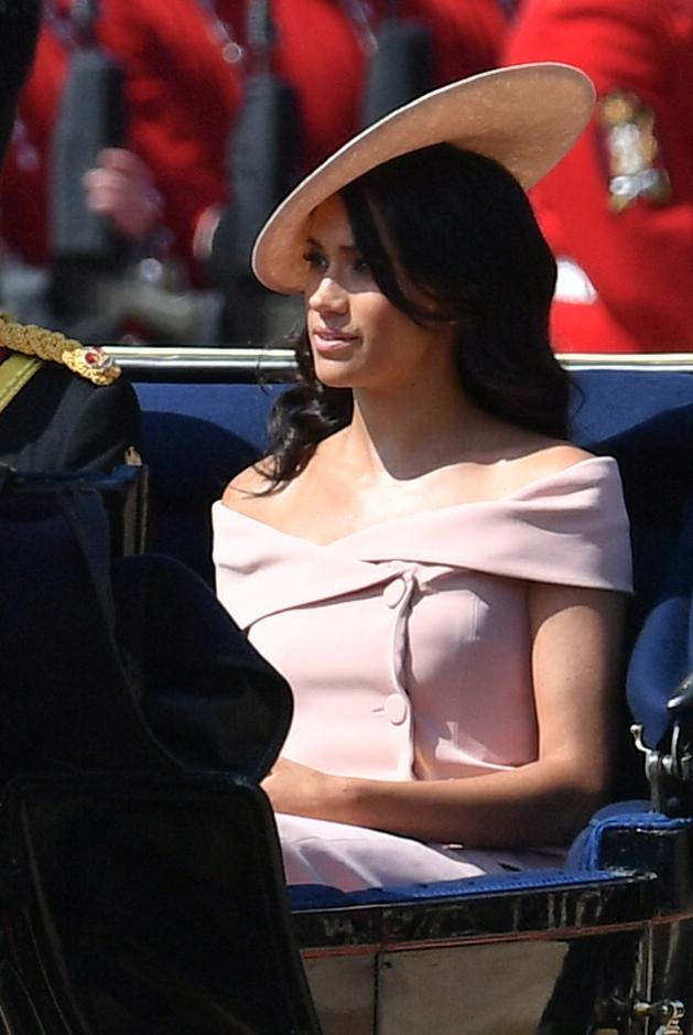  Meghan rode in a carriage with her husband, Prince Harry, greeted by hundreds of Guardsmen in their scarlet tunics and bearskins lined up on the parade ground - Henry VIII's former jousting yard - as the event began