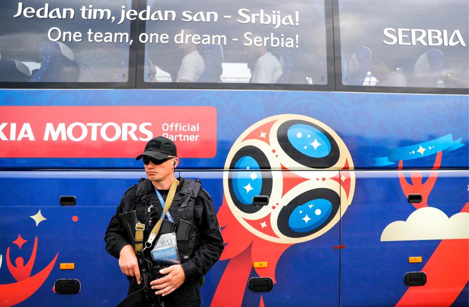  A security guard stands in front of the Serbia side inside their bus