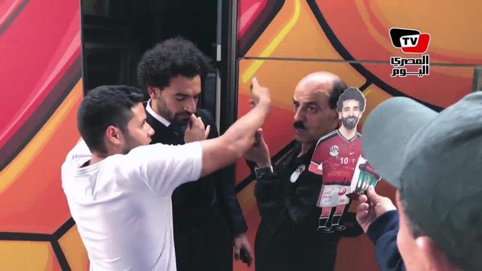  Salah then looked to be in pain as the fan put his arm around his injured shoulder