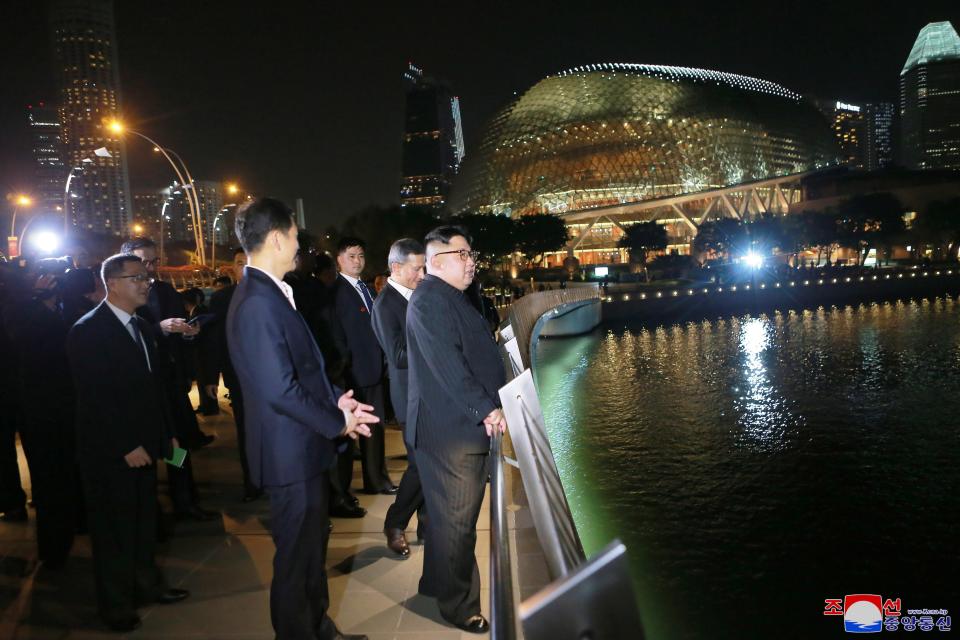  Paranoid Kim was flanked by bodyguards as he toured Singapore