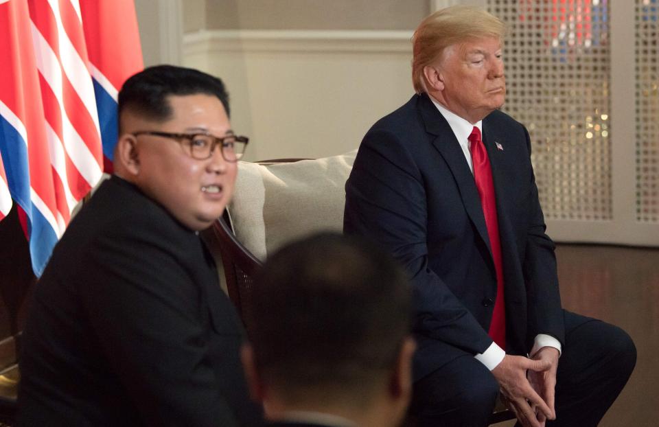  Trump sits with his hands in a hand in a reversed steeple gesture, a classic baseline gesture saying 'I’m more powerful than you'