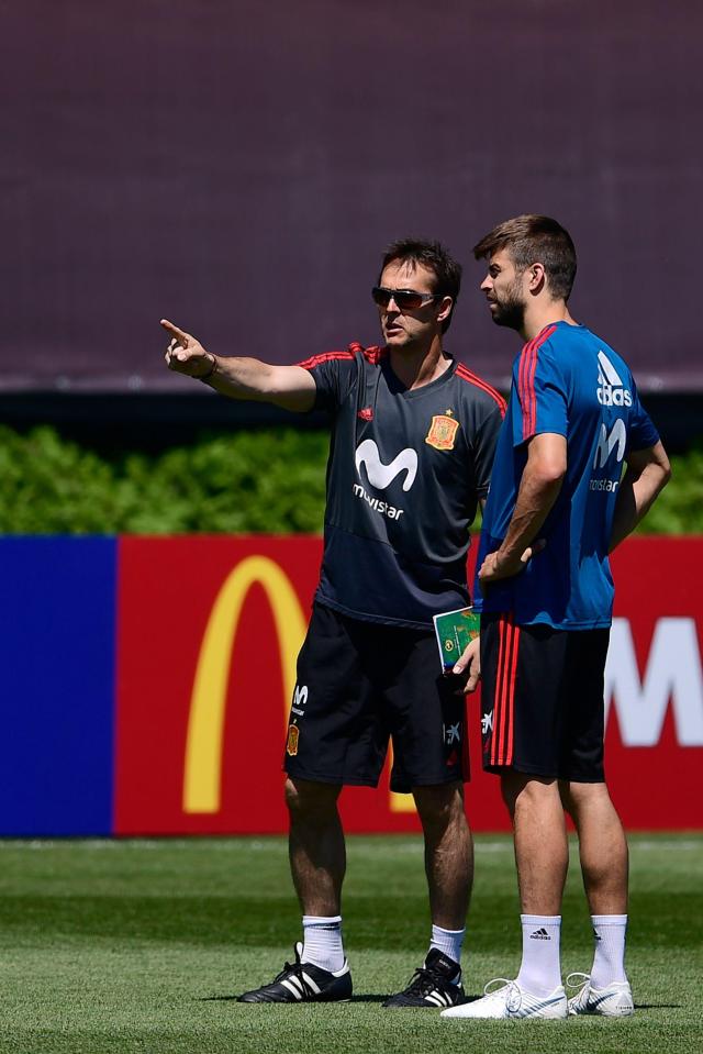 Julen Lopetegui gives out instructions to Gerard Pique during training