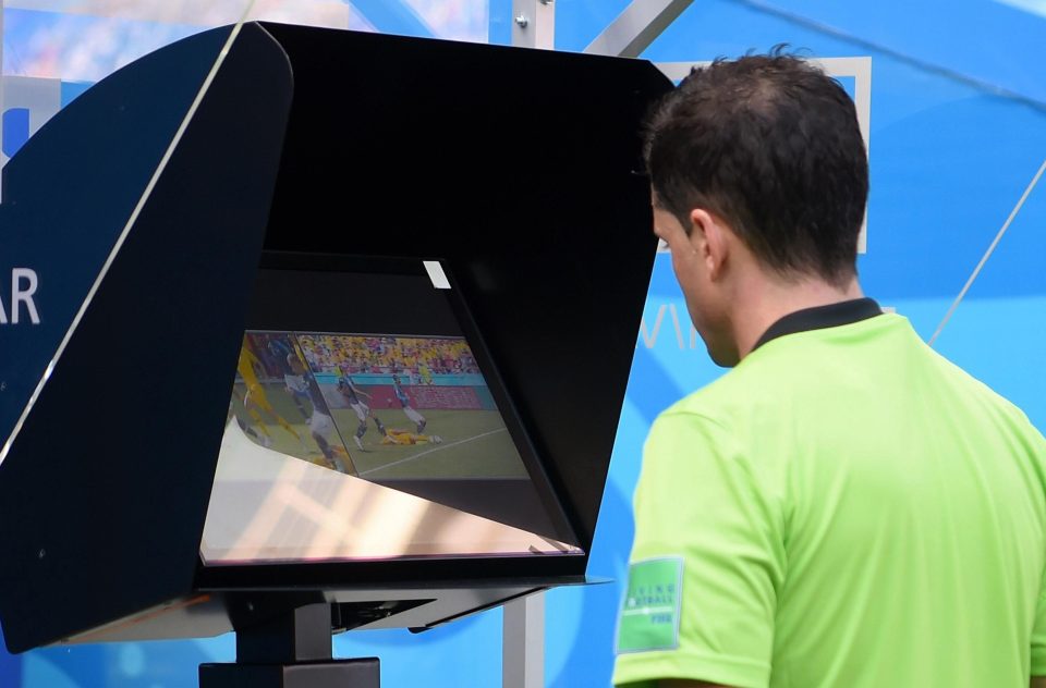  Referee watches a replay of the tackle on the screen