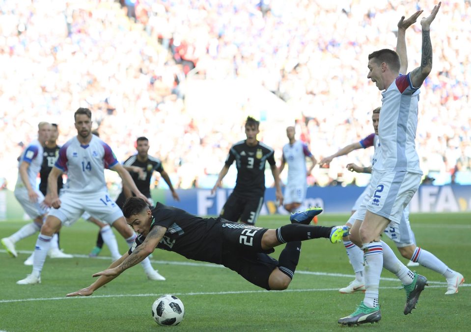  Argentina star Cristian Pavon appears to be brought down by Birkir Saevarsson