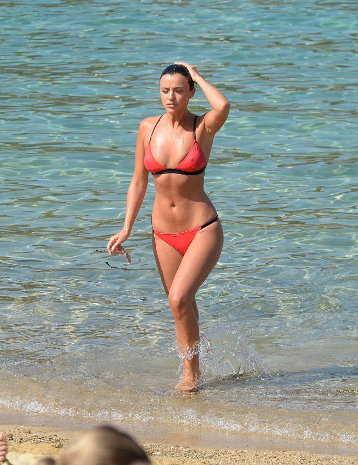  Lucy showed off her gym-honed curves in a teeny bright orange bikini