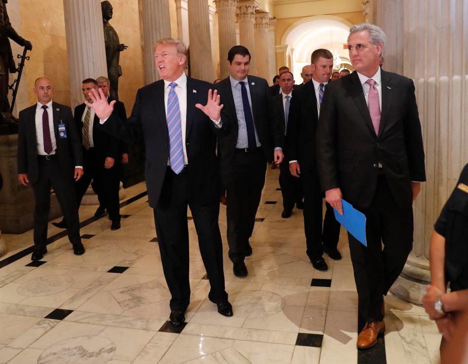  Trump walks with House Majority Leader Kevin McCarthy, right, while leaving the US Capitol in Washington after meeting with Republican leadership