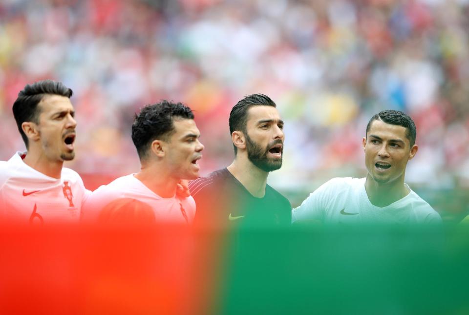  Cristiano Ronaldo faces the Portugal flag during the national anthem