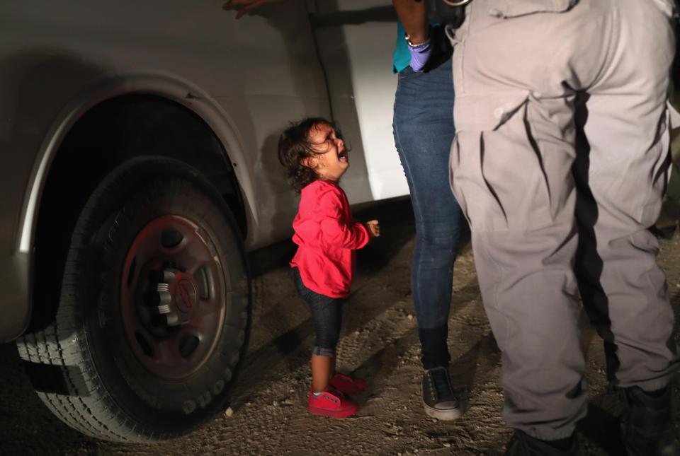  A two-year-old Honduran asylum seeker cries as her mother is detained near the US-Mexico border