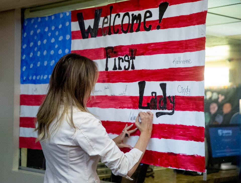  The first lady signed her name on the flag where the other children had also written their signatures