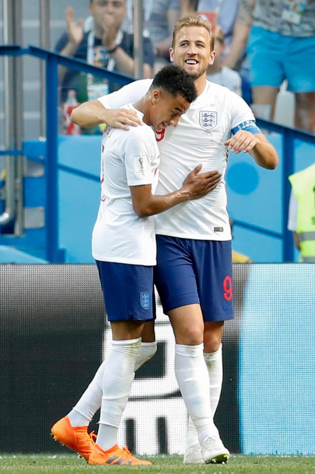  Jesse Lingard shares a hug with captain Harry Kane after scoring at the World Cup