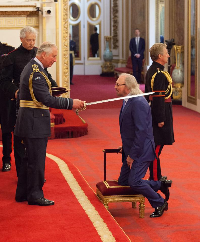  Bee Gees icon Barry Gibb is knighted by the Prince of Wales at Buckingham Palace