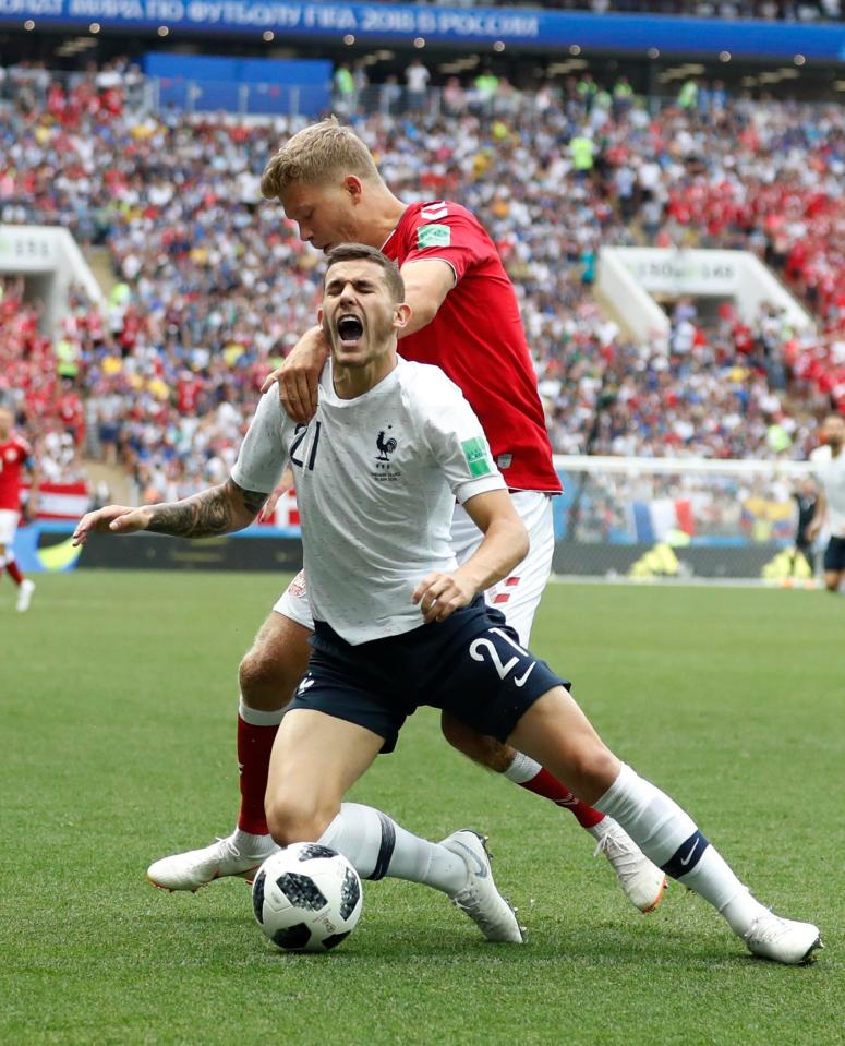 France's Lucas Hernandez goes tumbling after a challenge by Denmark's Andreas Cornelius