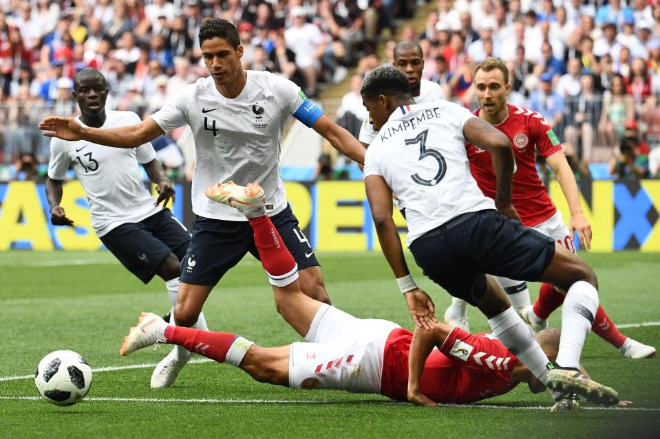 Martin Braithwaite (bottom) goes to ground beside French defenders Raphael Varane (2R) Presnel Kimpembe 