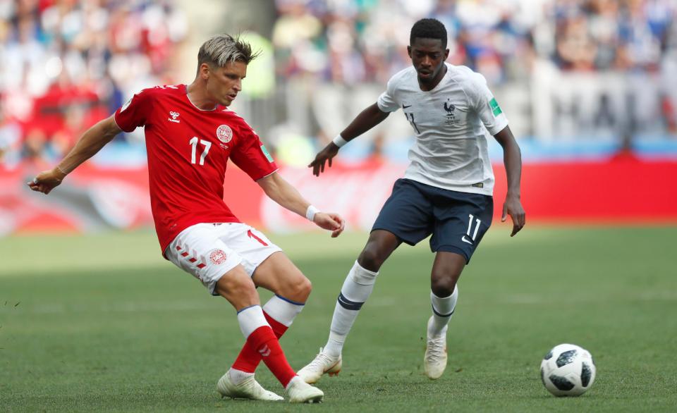 Denmark's Jens Stryger Larsen evades the challenge of France's Ousmane Dembele