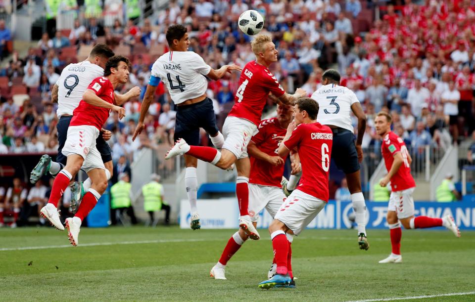 France's Raphael Varane in action with Denmark's Simon Kjaer