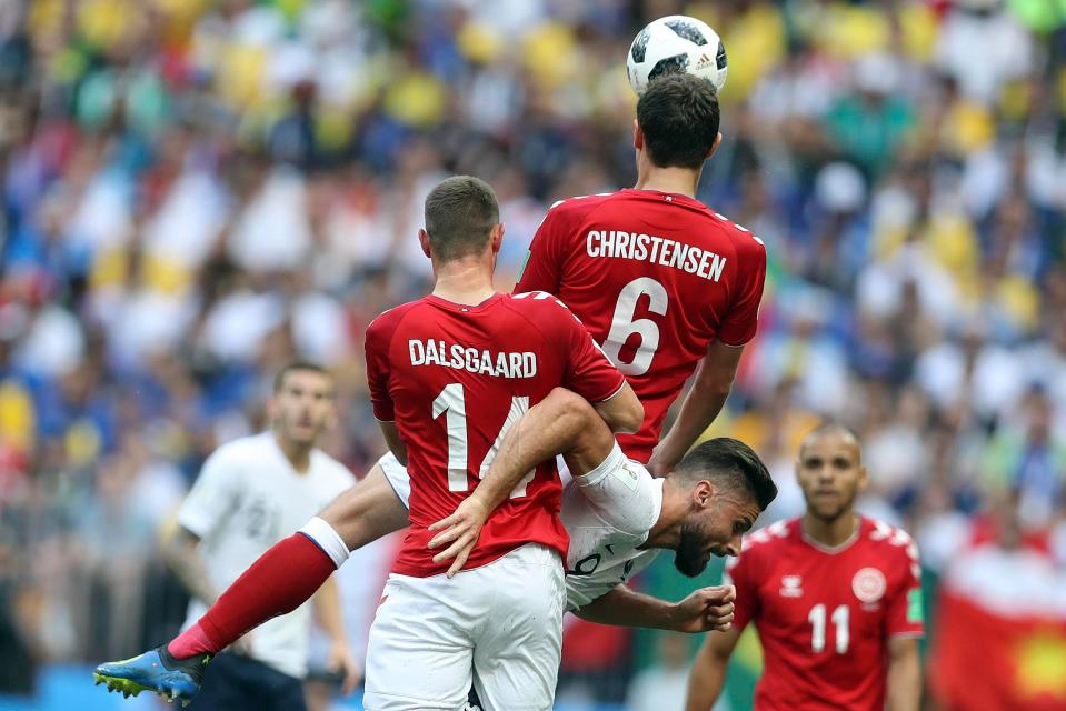 Denmark's Henrik Dalsgaard, front, and Andreas Christensen challenge France's Olivier Giroud for the ball 