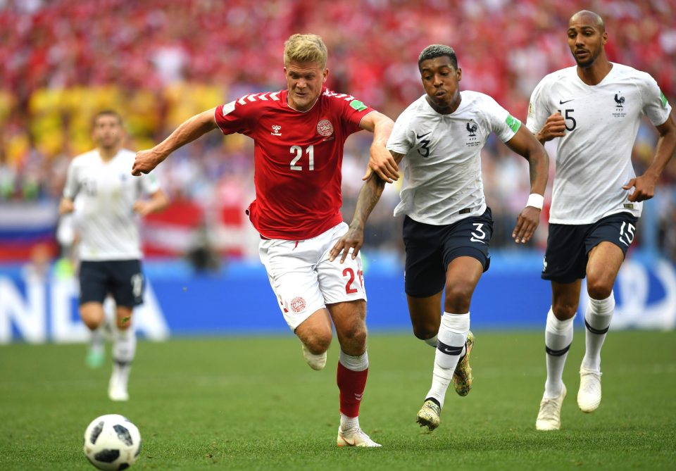 Andreas Cornelius of Denmark challenge for the ball with Presnel Kimpembe 