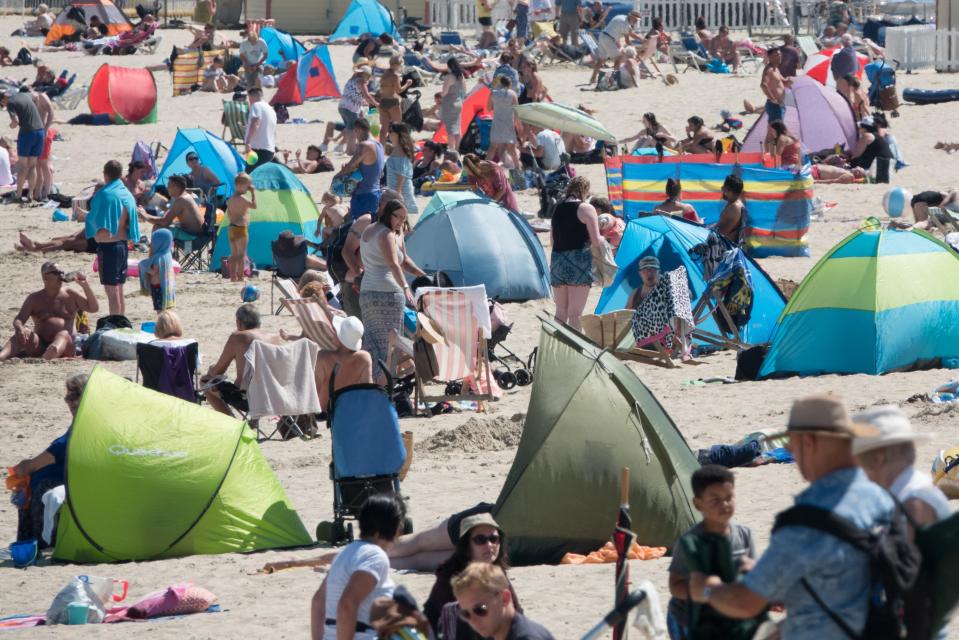 People enjoy the fine weather on the beach in Dorset