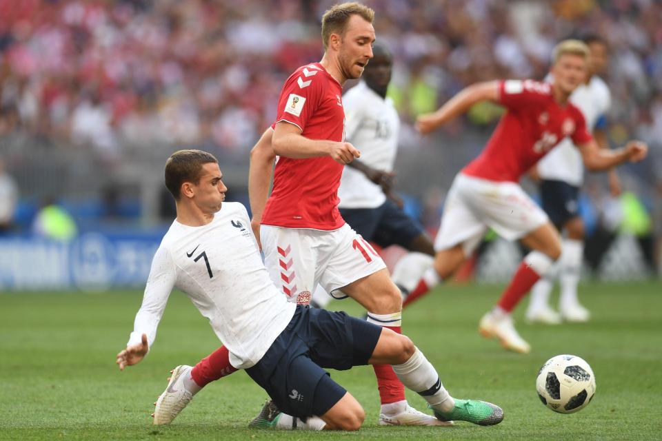 Antoine Griezmann (L) vies with Denmark's Christian Eriksen for the ball