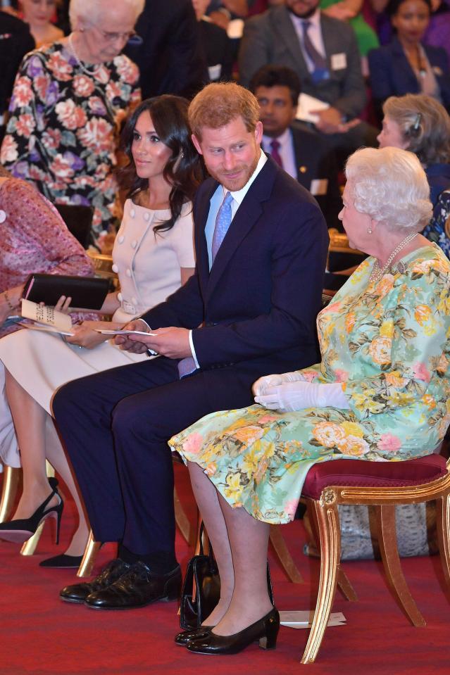 The Queen awards the recipients before hosting a reception at Buckingham Palace