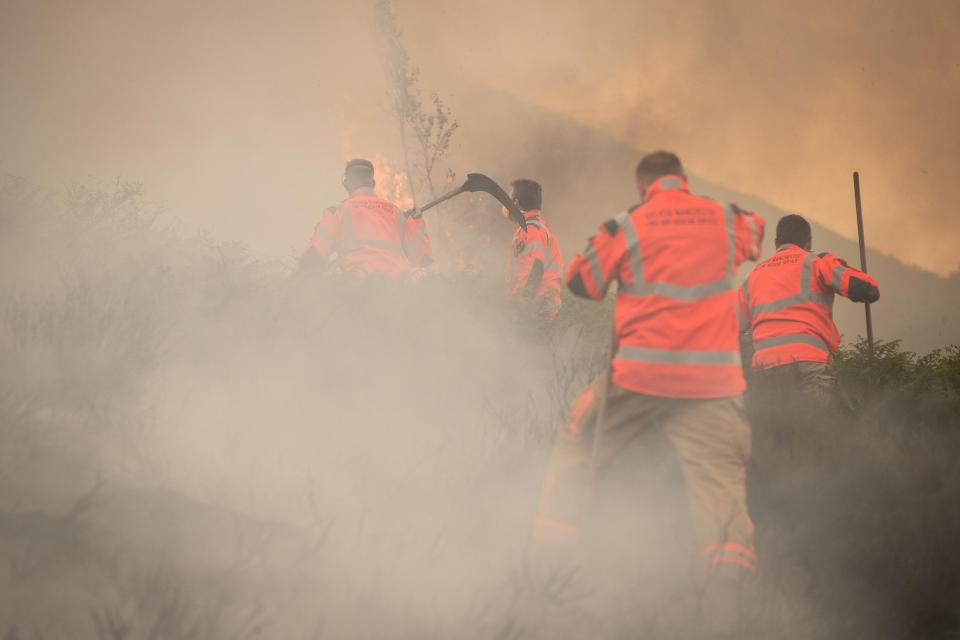 Greater Manchester Police said 34 homes have been evacuated so far as strong winds drive the flames closer to residential areas