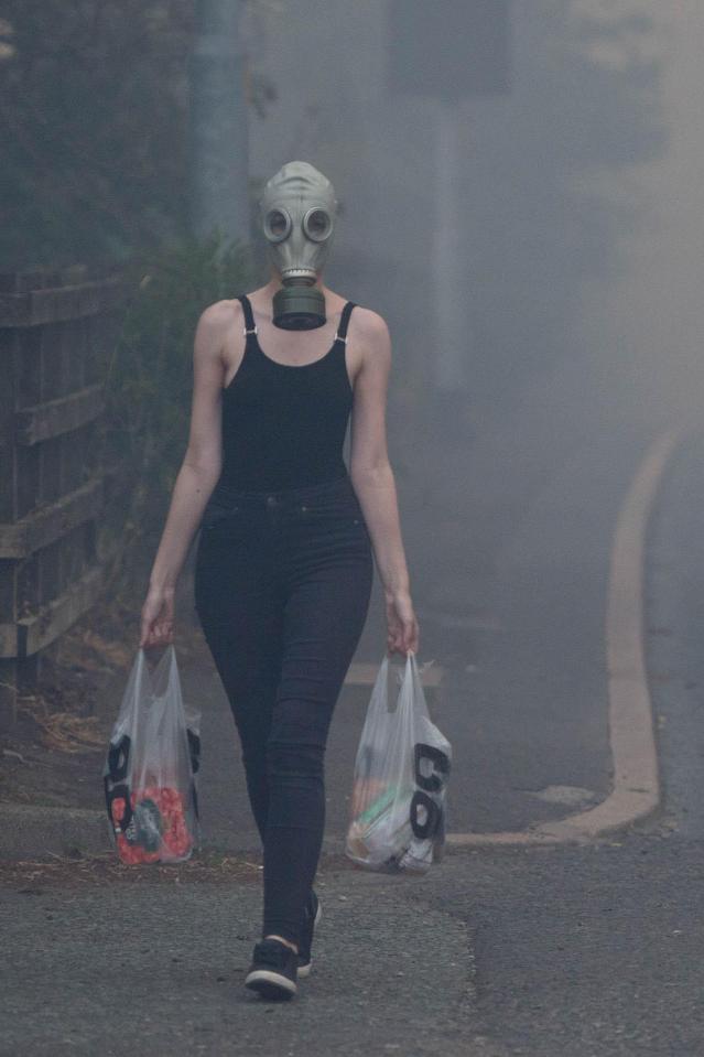 A lady wearing a gas mask on the way back from the shops this morning