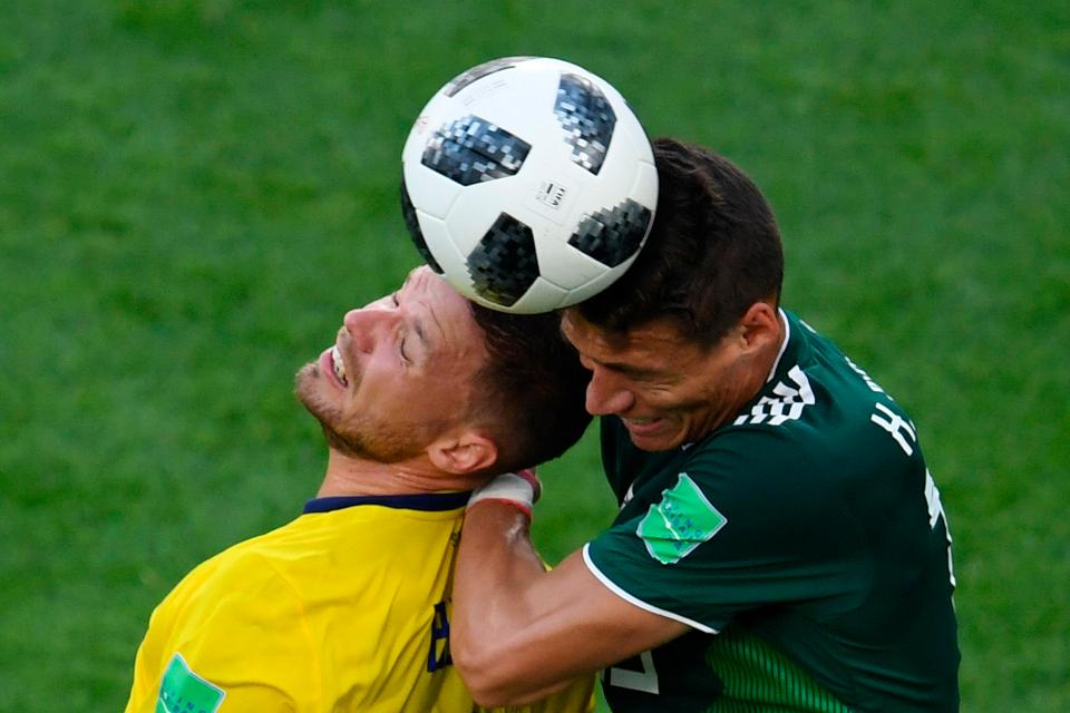  Sweden's Marcus Berg and Mexico's Hector Moreno vie for the ball