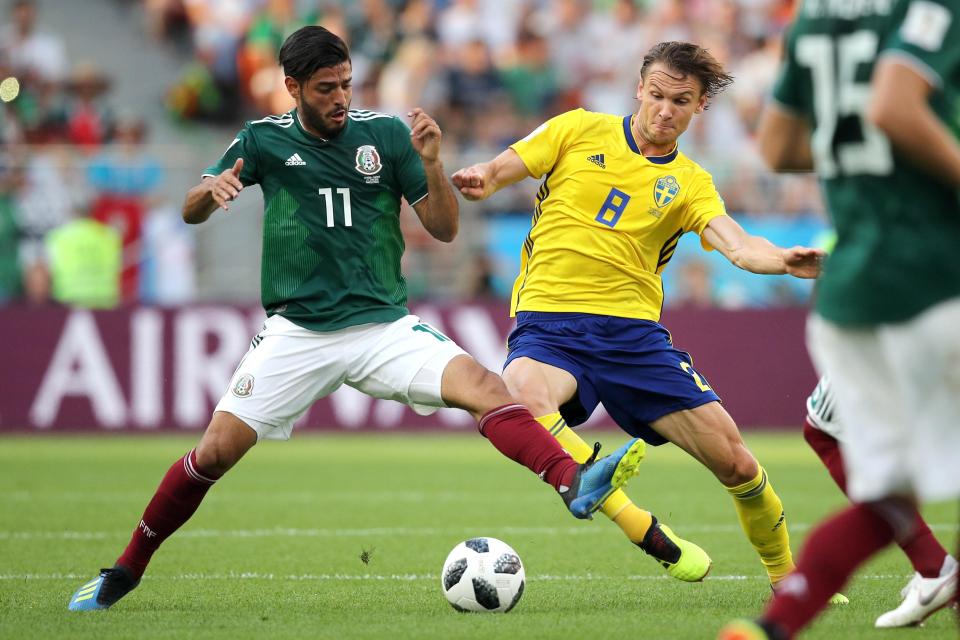  Mexico's Carlos Vela and Sweden's Albin Ekdal fight for the ball