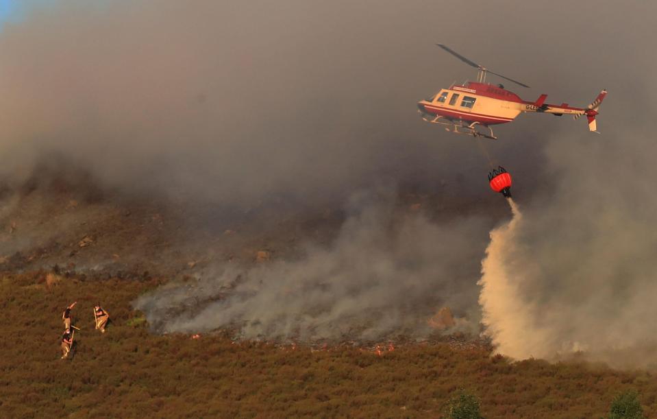 Helicopters have been drafted in to try and tame the flames on Saddleworth Moore