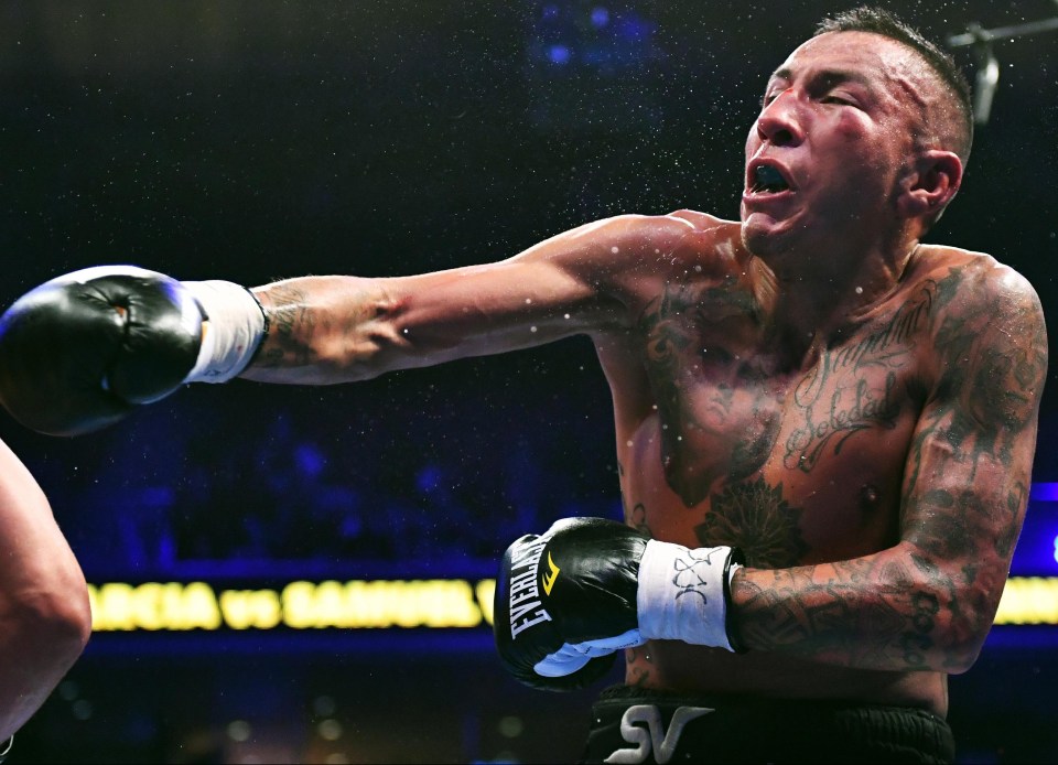 Sweat sprays off of Samuel Vargas after getting hit by Danny Garcia