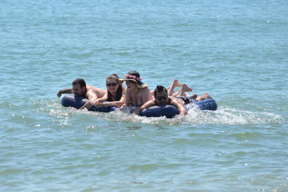 A group of friends make the most of the beach at Bournemouth as temperatures reach record-breaking heights today