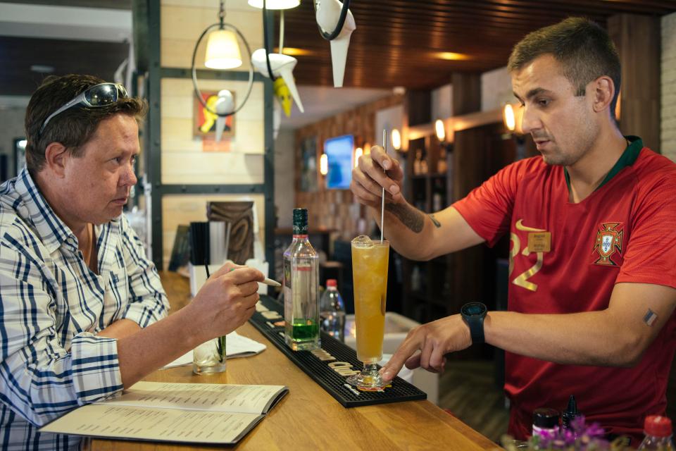  Neil waits as barman Andrey serves him up with Meldonium as his second drink